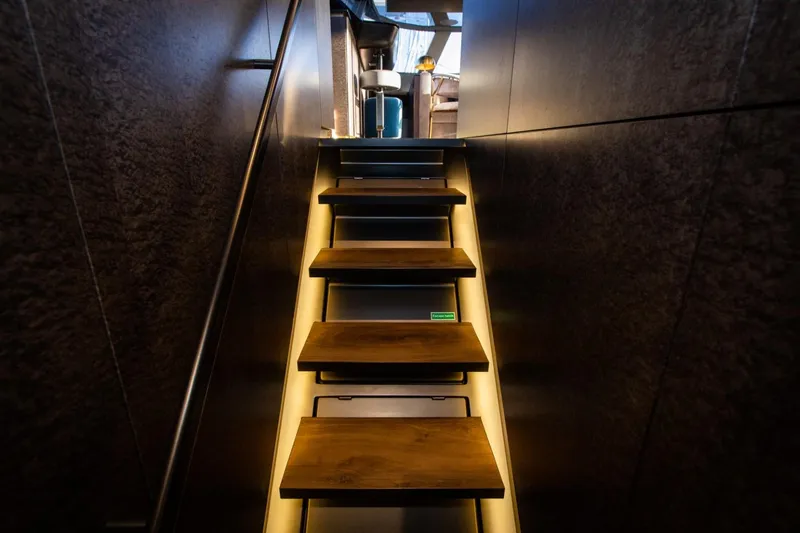 Mr. Si Yacht Photos Pics Staircase with wooden steps and ambient lighting on 2023 Sunreef 60 Sail yacht.
