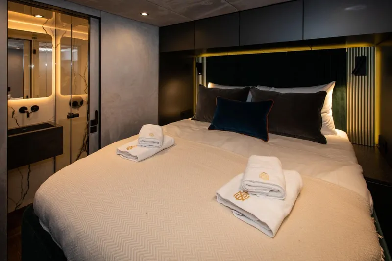 Mr. Si Yacht Photos Pics Luxurious bedroom interior of 2023 Sunreef 60 Sail yacht with elegant bedding and modern design.