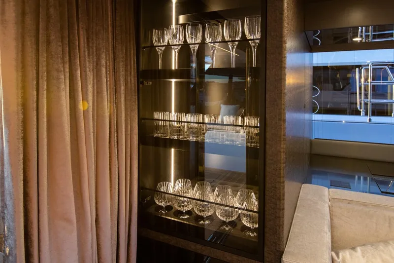 Mr. Si Yacht Photos Pics Luxurious interior of 2023 Sunreef 60 Sail yacht with elegant glassware display.