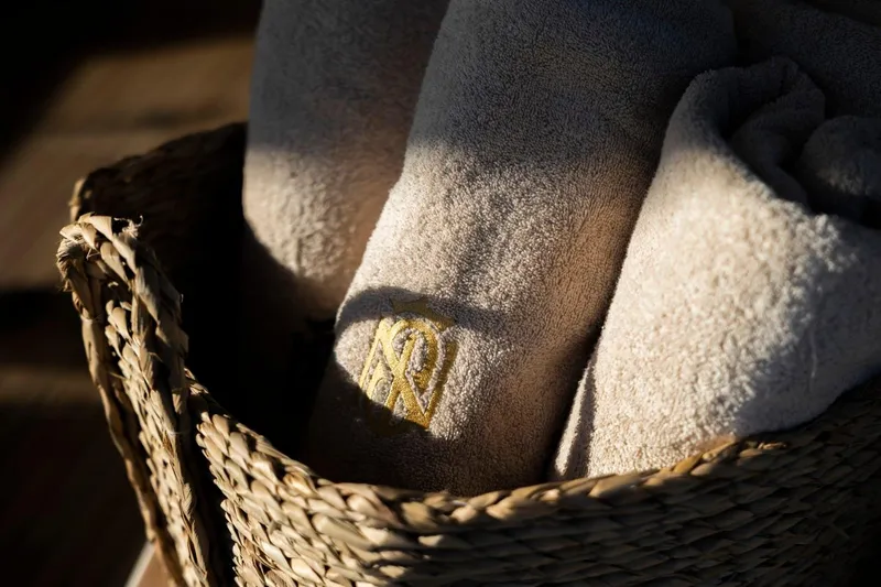 Mr. Si Yacht Photos Pics Luxurious towels in a woven basket aboard 2023 Sunreef 60 Sail yacht.