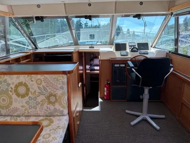 Thunderbolt Yacht Photos Pics Interior of a 1988 Riviera Convertible boat with helm, seating, and floral upholstery.