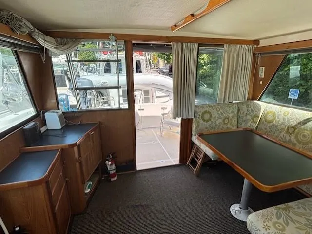 Thunderbolt Yacht Photos Pics Interior of a 1988 Riviera Convertible boat with dining area and cabinetry.