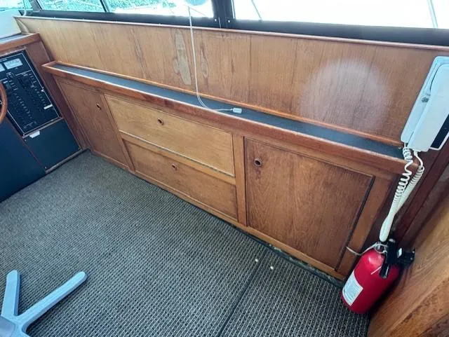 Thunderbolt Yacht Photos Pics 1988 Riviera Convertible interior with wooden cabinetry and fire extinguisher.
