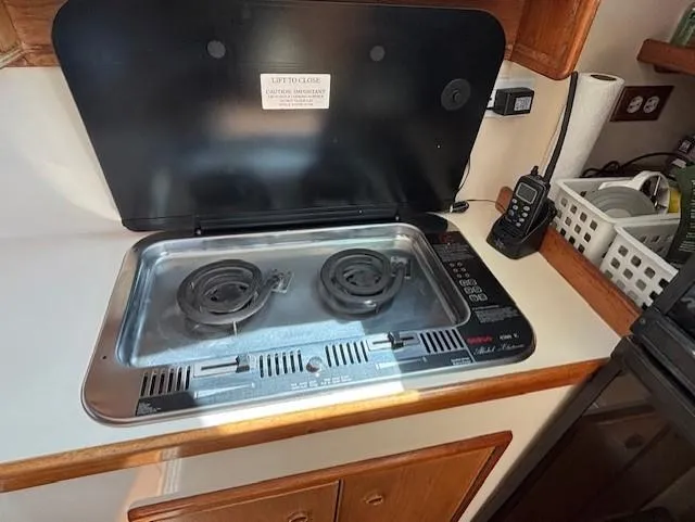 Thunderbolt Yacht Photos Pics 1988 Riviera Convertible kitchen with electric stove and communication device.