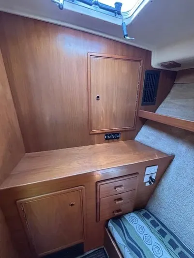 Thunderbolt Yacht Photos Pics 1988 Riviera Convertible cabin interior with wooden cabinetry and seating.