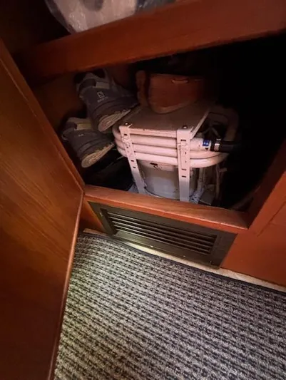 Thunderbolt Yacht Photos Pics Storage compartment in 1988 Riviera Convertible with shoes and folded chairs.