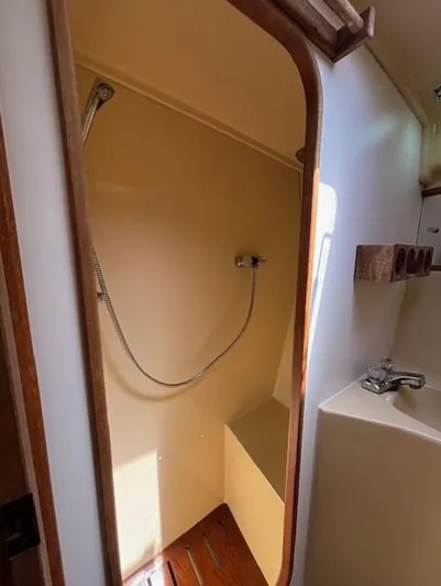 Thunderbolt Yacht Photos Pics 1988 Riviera Convertible boat bathroom with shower and sink.