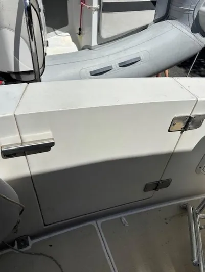 Thunderbolt Yacht Photos Pics 1988 Riviera Convertible boat interior with white panel and inflatable dinghy.
