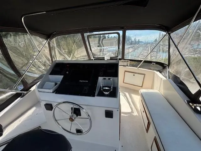 Thunderbolt Yacht Photos Pics 1988 Riviera Convertible boat interior with steering wheel and navigation controls.