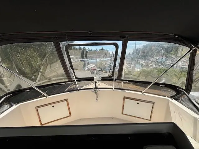 Thunderbolt Yacht Photos Pics 1988 Riviera Convertible boat interior with clear windows and marina view.
