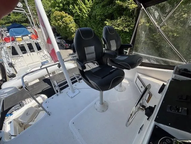 Thunderbolt Yacht Photos Pics 1988 Riviera Convertible boat helm with dual black seats and steering wheel.