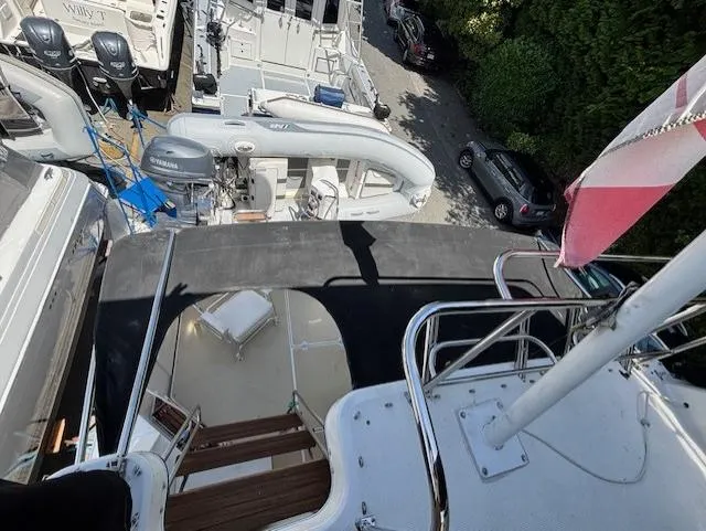 Thunderbolt Yacht Photos Pics 1988 Riviera Convertible yacht docked among other boats, view from upper deck.