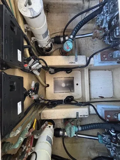 Thunderbolt Yacht Photos Pics Engine compartment of a 1988 Riviera Convertible boat, showing mechanical components and wiring.