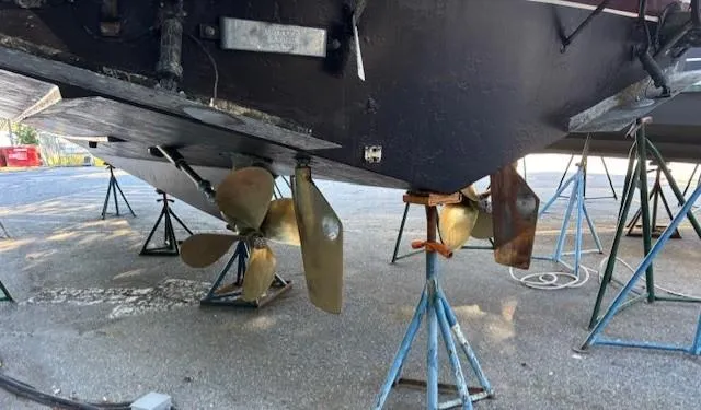 Thunderbolt Yacht Photos Pics 1988 Riviera Convertible boat on stands, showing propellers and hull underside.