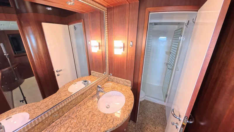 Arlene Yacht Photos Pics Luxurious yacht bathroom with granite countertop, wooden paneling, and glass shower door, Horizon Vision 2009.