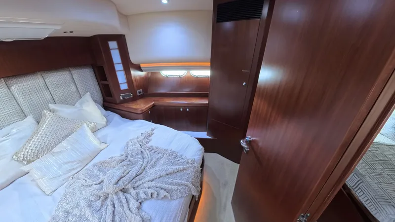 Arlene Yacht Photos Pics Luxurious cabin interior of 2009 Horizon Vision yacht with cozy bedding and wooden finishes.