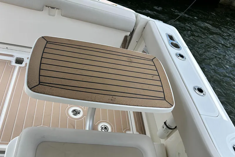  Yacht Photos Pics Boston Whaler 320 Vantage 2017 boat interior with wooden table and seating.