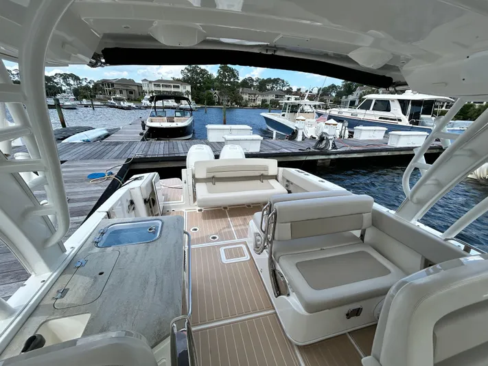  Yacht Photos Pics 2017 Boston Whaler 320 Vantage boat interior at marina, featuring spacious seating and modern design.