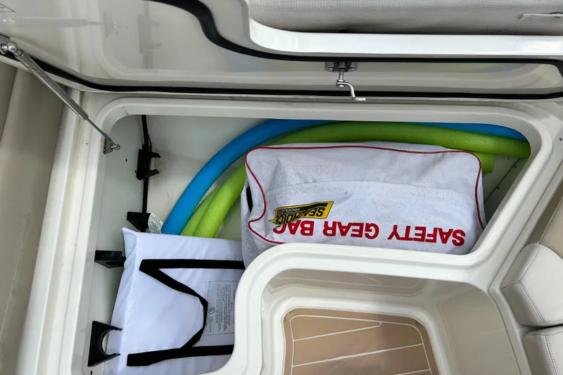  Yacht Photos Pics Storage compartment in a 2017 Boston Whaler 320 Vantage with safety gear and pool noodles.