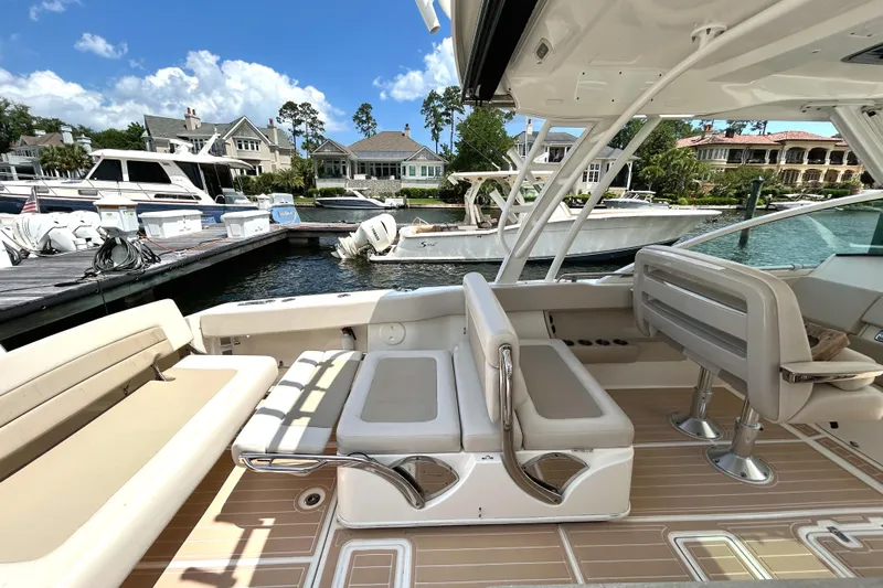  Yacht Photos Pics 2017 Boston Whaler 320 Vantage boat interior with seating, docked at marina.