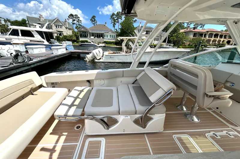  Yacht Photos Pics 2017 Boston Whaler 320 Vantage boat interior with seating, docked at marina.