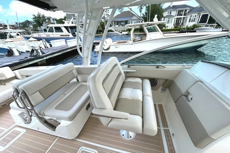  Yacht Photos Pics 2017 Boston Whaler 320 Vantage interior with luxurious seating at a marina.