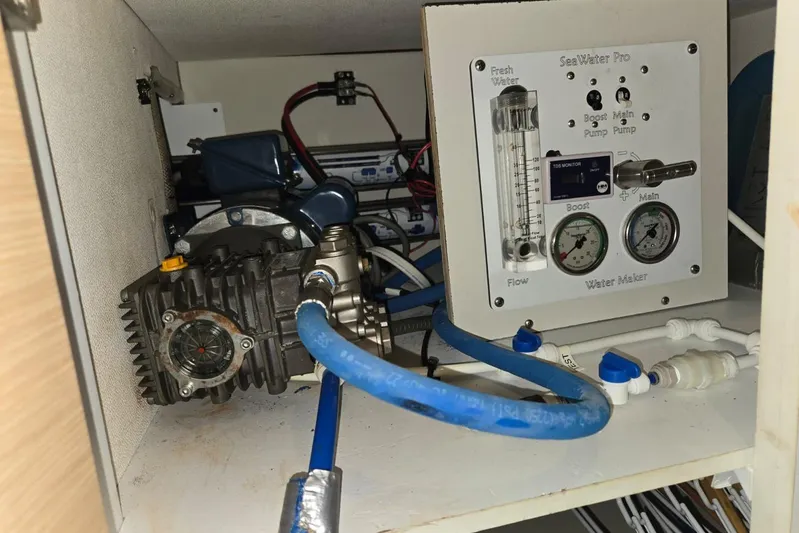 Sol Mates Yacht Photos Pics Water maker system inside 2018 Fountaine Pajot SABA 50 yacht, featuring gauges and blue tubing.