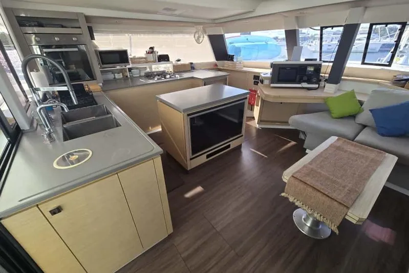Sol Mates Yacht Photos Pics Luxurious interior of 2018 Fountaine Pajot SABA 50 catamaran with modern kitchen and seating area.