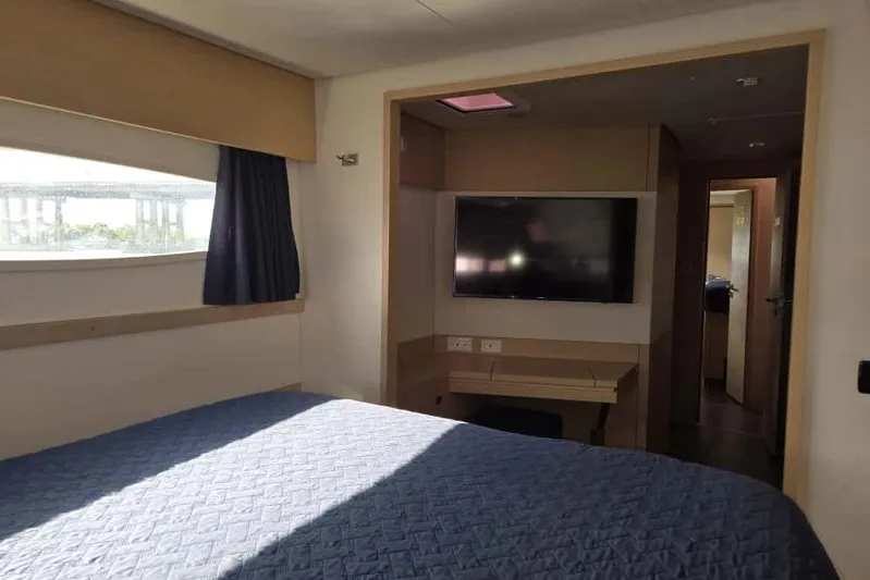 Sol Mates Yacht Photos Pics Interior of 2018 Fountaine Pajot SABA 50 yacht cabin with bed and TV.