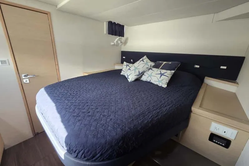 Sol Mates Yacht Photos Pics Cabin interior of 2018 Fountaine Pajot SABA 50 with cozy bed and nautical decor.