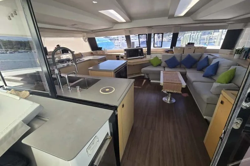 Sol Mates Yacht Photos Pics Luxurious interior of 2018 Fountaine Pajot SABA 50 catamaran with modern kitchen and cozy seating area.