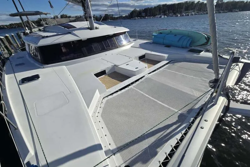 Sol Mates Yacht Photos Pics 2018 Fountaine Pajot SABA 50 catamaran docked, featuring spacious deck and netting.
