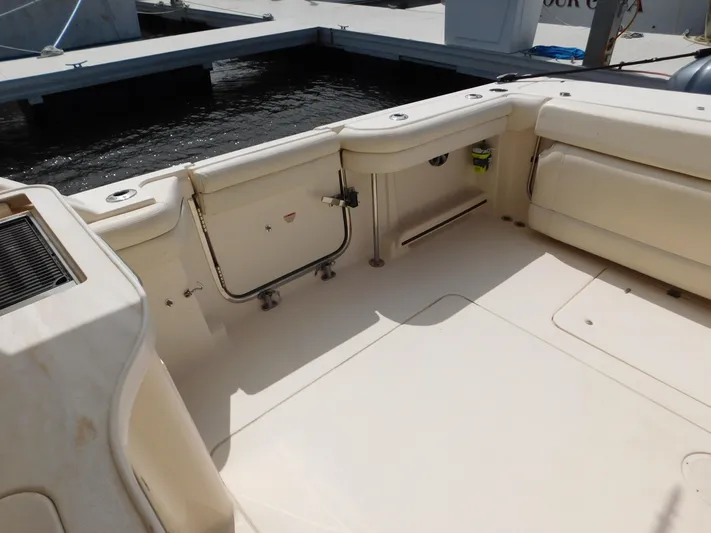 Here & Now Yacht Photos Pics 2018 Grady-White Freedom 375 boat interior, featuring spacious seating and storage at the dock.