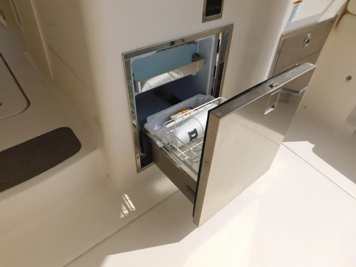 Here & Now Yacht Photos Pics Built-in refrigerator on 2018 Grady-White Freedom 375 boat, open with visible contents.