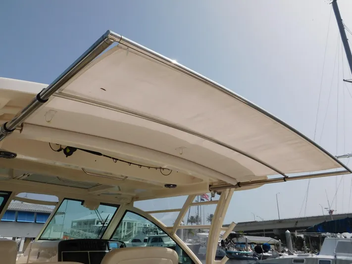 Here & Now Yacht Photos Pics 2018 Grady-White Freedom 375 boat with retractable sunshade, docked at marina.