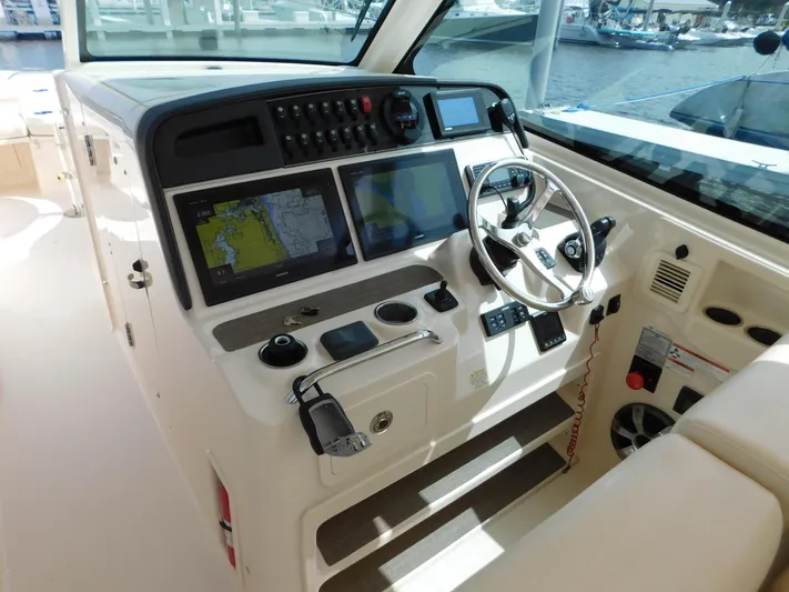 Here & Now Yacht Photos Pics 2018 Grady-White Freedom 375 helm with advanced navigation systems and controls.