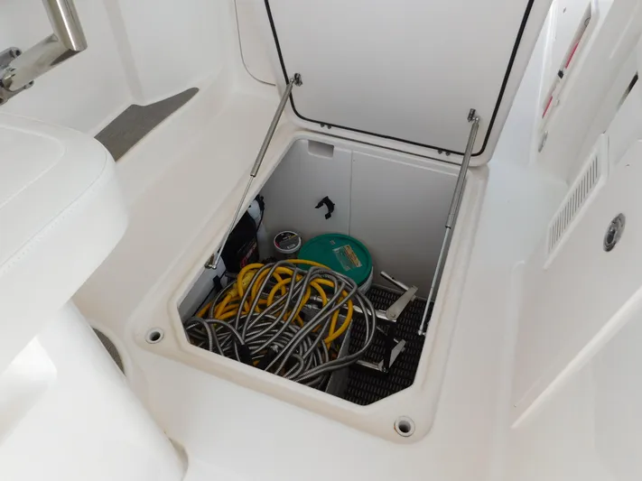Here & Now Yacht Photos Pics Storage compartment on 2018 Grady-White Freedom 375 boat with hoses and equipment.