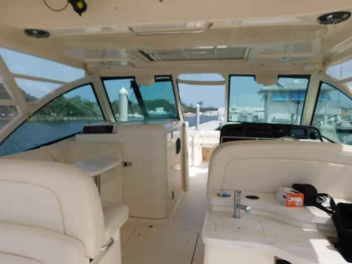 Here & Now Yacht Photos Pics 2018 Grady-White Freedom 375 boat interior with seating and helm, docked at marina.