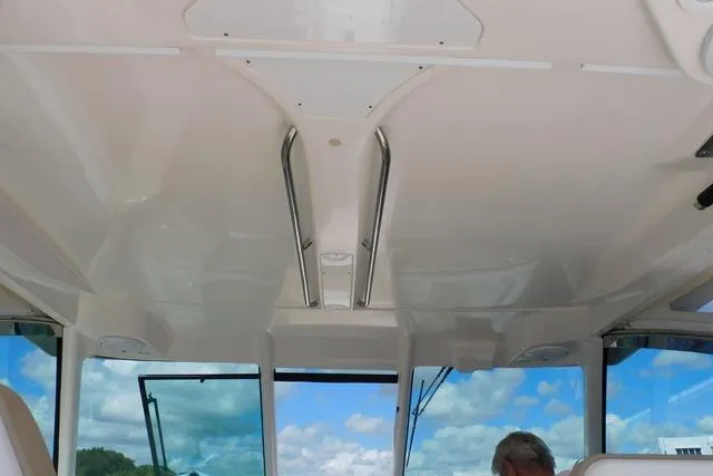  Yacht Photos Pics 2016 Pursuit DC 325 Dual Console boat interior with clear sky view through windows.