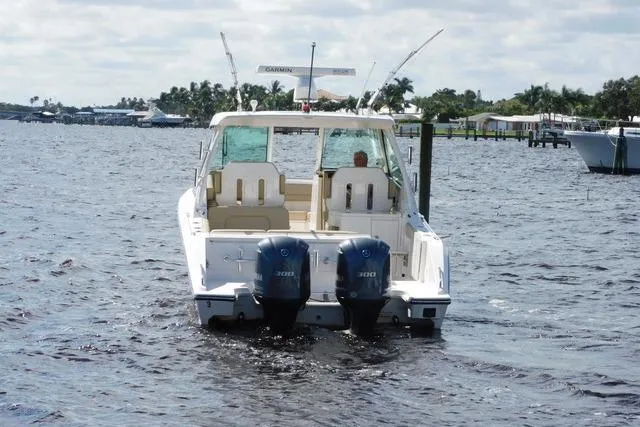  Yacht Photos Pics 2016 Pursuit DC 325 Dual Console boat on water, featuring twin engines.