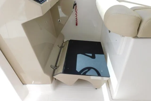  Yacht Photos Pics 2016 Pursuit DC 325 Dual Console boat interior with foldable step and beige seating.