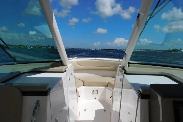  Yacht Photos Pics 2016 Pursuit DC 325 Dual Console boat on open water under blue sky.