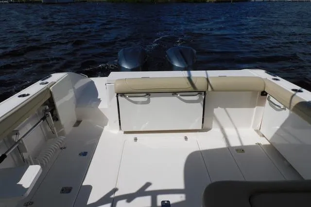  Yacht Photos Pics 2016 Pursuit DC 325 Dual Console boat interior with seating and twin engines on water.