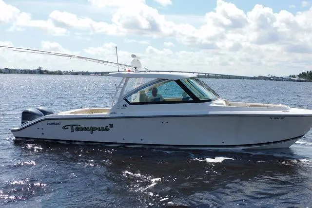  Yacht Photos Pics 2016 Pursuit DC 325 Dual Console boat cruising on a sunny day.