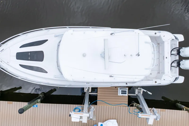  Yacht Photos Pics Aerial view of 2023 Intrepid 345 Valor boat docked, showcasing sleek design and twin engines.