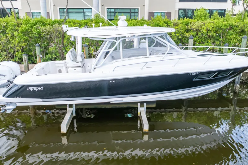  Yacht Photos Pics 2023 Intrepid 345 Valor boat docked, featuring sleek design and modern amenities.