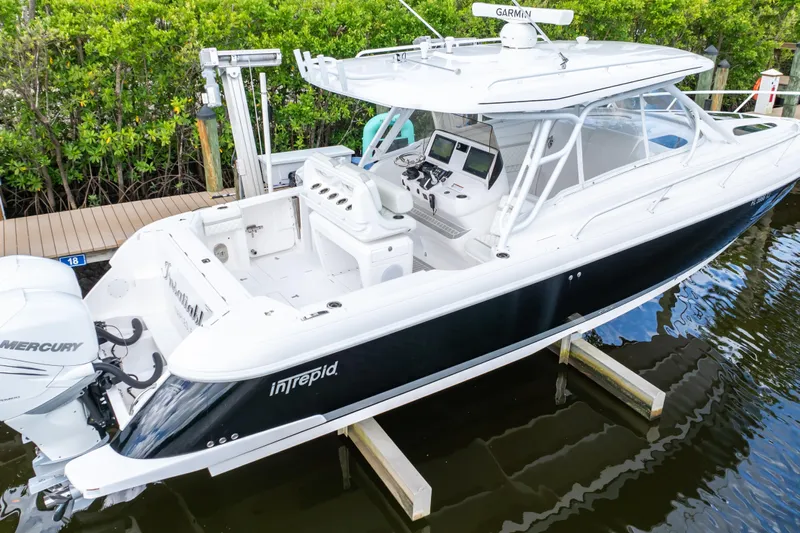  Yacht Photos Pics 2023 Intrepid 345 Valor boat docked, featuring sleek design and advanced navigation equipment.