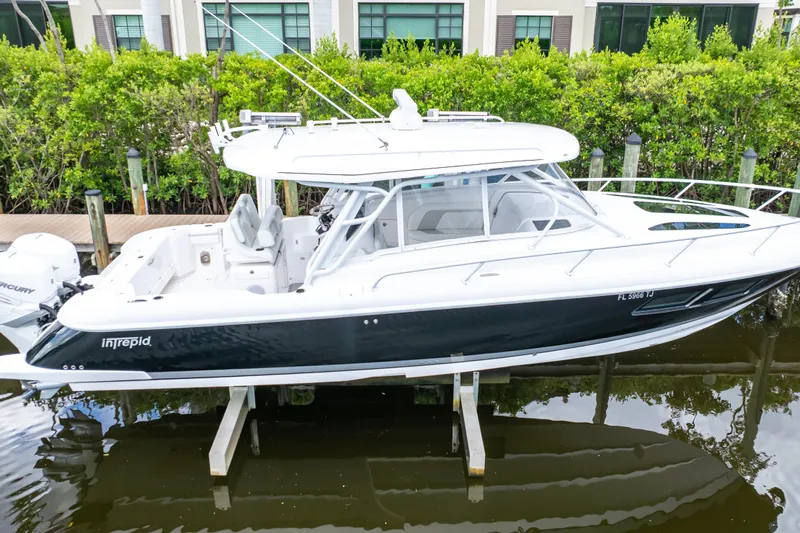  Yacht Photos Pics 2023 Intrepid 345 Valor boat docked, featuring sleek design and modern amenities.