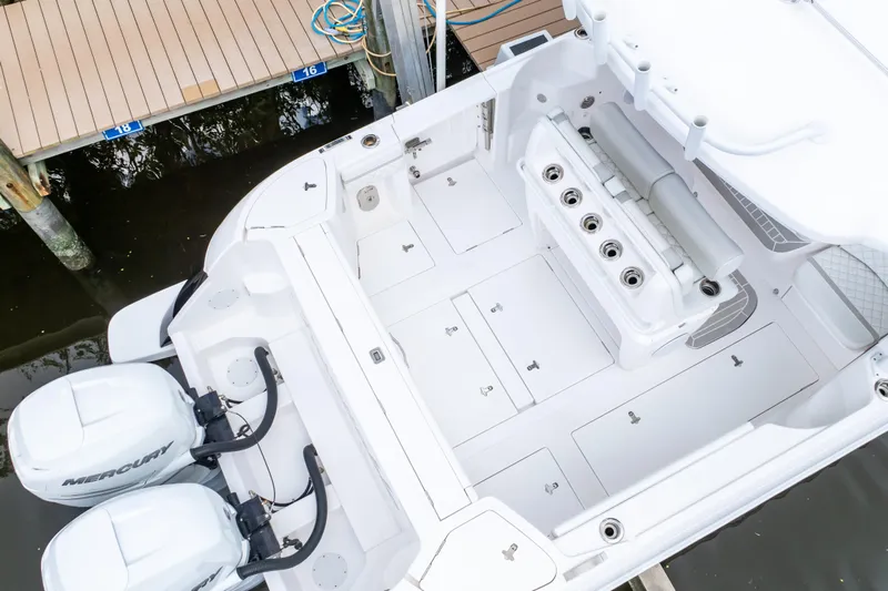  Yacht Photos Pics 2023 Intrepid 345 Valor boat interior with dual Mercury engines at dock.