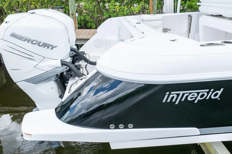  Yacht Photos Pics 2023 Intrepid 345 Valor boat with Mercury Verado engine, docked on calm water.
